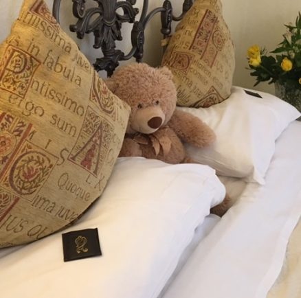 A teddy bear on a bed