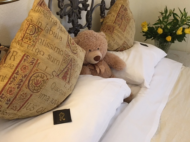 A teddy bear on a bed